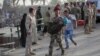 An Iraqi soldier carries a girl displaced by fighting in Ramadi across a bridge at the outskirts of Baghdad, May 19, 2015. 