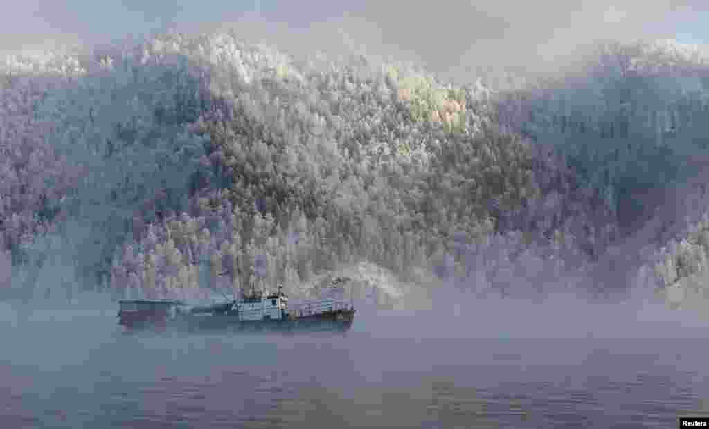 A motor boat sails along the Yenisei River, with the air temperature at about minus 20° C (- 4°F), outside the Siberian city of Krasnoyarsk, Russia.