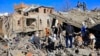 Yemenis inspect the damage following overnight air strikes by the Saudi-led coalition targeting the Huthi rebel-held capital Sanaa, Jan. 18, 2022. 