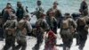 U.S. Marines from Company B, 1st Battalion Landing Team, 5th Marines, 31st Marine Expeditionary Unit and their Philippine counterparts, prepare to board their rubber boat with a mock captured suspect during joint exercises, April 15, 2013.