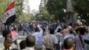 Protesters try to stop the stone throwing after scuffles broke out between groups of several hundred protesters in Tahrir square when chants against the new Islamist president angered some in the crowd in Cairo, Egypt, October 12, 2012.