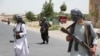 FILE - Former Mujahideen hold weapons to support Afghan forces in their fight against Taliban, on the outskirts of Herat province, Afghanistan, July 10, 2021. 