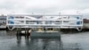 FILE - The Energy Tide 2, the largest tidal energy turbine ever deployed in the U.S., appears on a barge in Portland, Maine. 