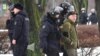 Police officers detain a man as people come to a monument to the victims of Soviet political repressions to lay flowers for late Russian opposition leader Alexei Navalny in St. Petersburg on Feb. 17, 2024, one day after the death of Navalny in an Arctic prison.