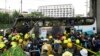 Rescuers inspect a bus that caught fire as it was carrying young students with their teachers, in suburban Bangkok, Oct. 1, 2024. 
