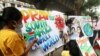 Students apply finishing touches to paintings made to create an awareness against the new coronavirus Omicron variant, in Mumbai, India, November 29, 2021.