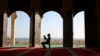 FILE - A Palestinian youth reads verses of the Quran, Islam's holy book, during the holy Islamic month of Ramadan at the beach side Mosque in Gaza City, June 9, 2016. 