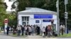 FILE - Journalists gather at a hospital where Russian opposition leader Alexei Navalny had been hospitalized, in Moscow, July 29, 2019. 