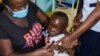Jeywellan Ochieng, 2, reacts after receiving the vaccine against malaria as she is held by her mother, Julliet Achieng, at the Yala Sub County Hospital Mother and Child Healthcare (MCH) clinic in Gem, Siaya County, Kenya, October 7, 2021. 