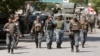 Afghan policemen arrive at the site of an attack and gun fire in Kabul, May 9, 2018. 