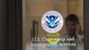 FILE - A security guard looks out of the U.S. Citizenship and Immigration Services offices in New York, Aug. 15, 2012.