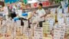 A Thai vendor weighs a bag of rice at a market in central Bangkok, July 26, 2013.