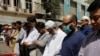 A man wears a protective mask as a preventive measure amid coronavirus fears, as he attends Friday prayers with others in Karachi, Pakistan, March 13, 2020. 