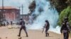Uganda police officers conftont students of Makerere university during their protest against the 15 percent tuition increment in Kampala, Oct. 30, 2019. Police allegedly assaulted four journalists who covered the protest.