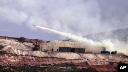 Turkish artillery fires toward Syrian Kurdish positions in Afrin area, Syria, from Turkish side of the border in Hatay, Turkey, Feb. 9, 2018. Turkish jets have resumed airstrikes in the Syrian Kurdish-run enclave of Afrin, the military and media reports 