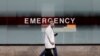 FILE - A doctor wears a protective mask as he walks outside Mount Sinai Hospital in Manhattan during the outbreak of coronavirus in New York City, April 1, 2020. 