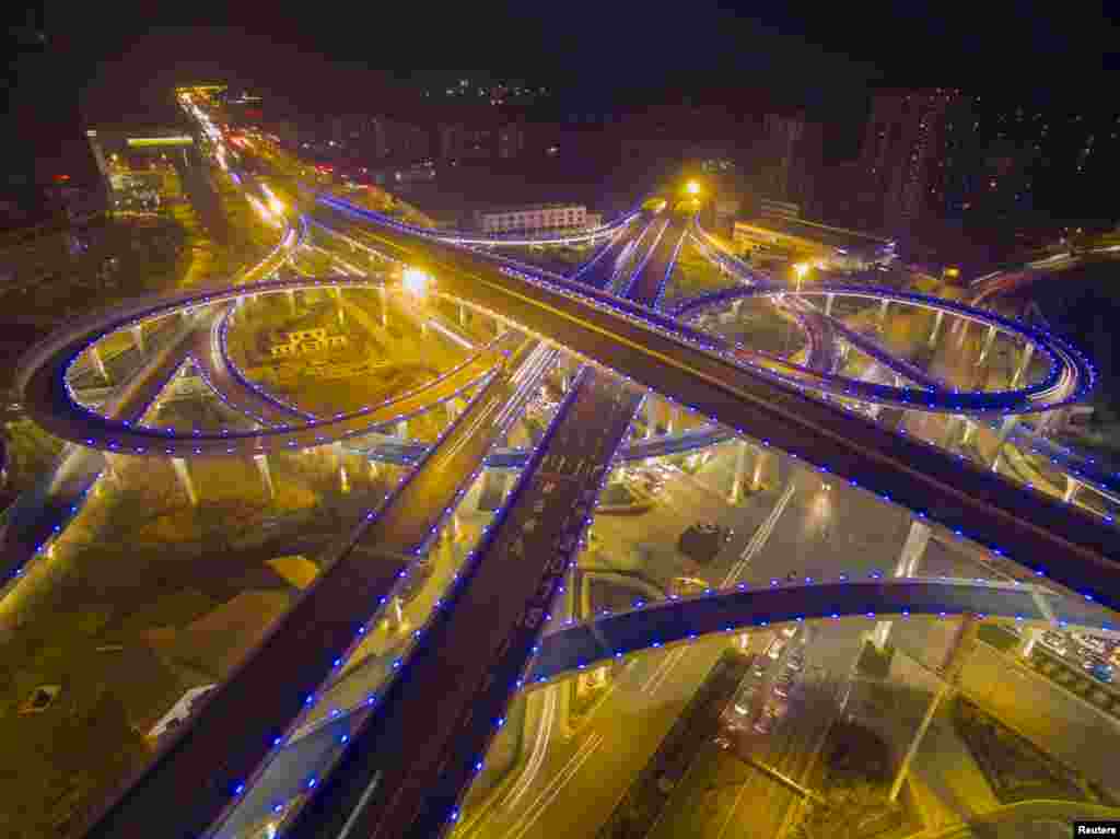 An overpass lighted in blue is seen during a hazy evening in Jinan, Shandong province, China, Dec. 28, 2015.