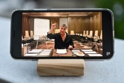 FILE - A photo taken May 26, 2021, in Istanbul, Turkey, shows a YouTube broadcast by exiled mob boss Sedat Peker on a mobile phone.