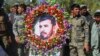 Military personnel held a photo of Gen. Abdul Raziq, Kandahar police chief, who was killed by a guard, during his burial ceremony in Kandahar, Afghanistan, Oct. 19, 2018.