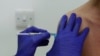 In this Wednesday, Oct. 7, 2020, file photo, a Phase 3 Novavax coronavirus vaccine trial volunteer is given an injection at St George's University hospital in London. (AP Photo/Alastair Grant, File)