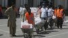 Volunteers deliver food relief packages for the Muslim fasting month of Ramadan, during a government-imposed nationwide lockdown to help contain the spread of the new coronavirus, in Peshawar, Pakistan, May 4, 2020.