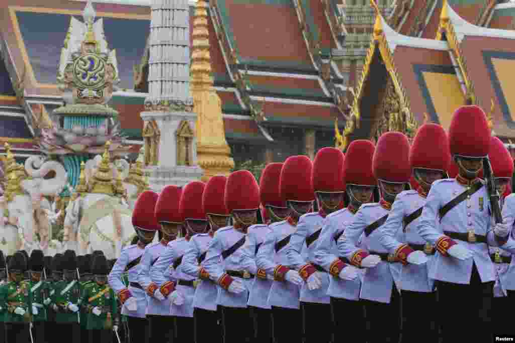 Thai Royal Guards march in front of the Grand Palace during a military parade as a part of a celebration for the upcoming birthday of King Bhumibol Adulyadej in Bangkok, Thailand. The revered King, the world&#39;s longest reigning monarch, will turn 88 on Dec. 5.