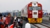 FILE - Kenyan President Uhuru Kenyatta watches a cargo train carrying port containers begin its opening run from Mombasa to Nairobi, Kenya, May 30, 2017. The project was financed by China.