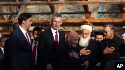 Afghan President Ashraf Ghani, center, arrives with NATO Secretary General Jens Stoltenberg, and U.S. Secretary of Defense Mark Esper for a joint news conference in presidential palace in Kabul, Afghanistan, Feb. 29, 2020. 