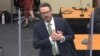 Defense attorney Eric Nelson mimics someone feigning a medical emergency as he makes closing arguments during the trial of former Minneapolis police officer Derek Chauvin for second-degree murder.