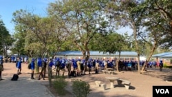 Pupils at a private school in Harare queue for temperature checks before they starts lessons, Nov. 11, 2020. (Columbus Mavhunga/VOA)