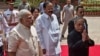 Indian President Pranab Mukherjee (R) arrives with Indian Prime Minster Narendra Modi (L) to address the joint session of Parliament in New Delhi, India, June 9, 2014. 