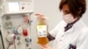 FILE - A nurse holds a bag of plasma from a recovered COVID-19 donor, at the Belgian Red Cross blood collection center in Brussels, Belgium, Oct. 27, 2020. 