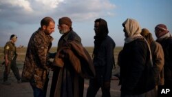 A man is frisked by a U.S.-backed Syrian Democratic Forces fighter after being evacuated out of the last territory held by Islamic State militants, near Baghuz, eastern Syria, Feb. 22, 2019.