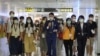 FILE - People who want to leave the island, but cannot due to COVID-19 travel restrictions, take part in a 'fake' travel experience for tourists simulating the experience of using an international airport at Songshan airport in Taipei, July 2, 2020. 