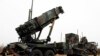 A camouflaged convoy of Dutch military trucks carrying two batteries of Patriot missiles is lined up for a media opportunity before departing De Peel Air Base in Vreedepeel, southern Netherlands, Jan. 7, 2013.