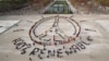 FILE - In this Dec. 6, 2015 file photo, environmentalist activists form a human chain representing the peace sign and the spelling out "100% renewable", on the side line of the COP21, United Nations Climate Change Conference near the Eiffel Tower in Paris