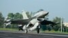 A Taiwan Air Force F-16 fighter jet lands on a closed section of highway during the annual Han Kuang military exercises in Chiayi, central Taiwan, Sept. 16, 2014. 