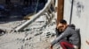 A Palestinian boy reacts near the site of an Israeli strike on a house, in Rafah, in the southern Gaza Strip