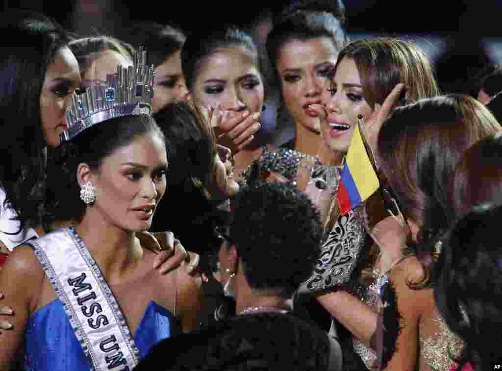Contestants comfort Miss Colombia, Ariadna Gutierrez, top right, after she was incorrectly crowned Miss Universe at the Miss Universe pageant in Las Vegas, Dec. 20, 2015. Host Steve Harvey made a mistake when announcing the first runner-up, Miss Colombia, as the winner before they took it away and gave it to Miss Philippines Pia Alonzo Wurtzbach, pictured on the left.