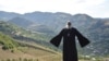 Priest Ter Abel prays for peace outside the village of Movses on the Armenian-Azerbaijani border on July 15, 2020. 