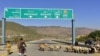 FILE - A Pakistani motorcyclist drives on a newly built Pakistan China Silk Road in Haripur, Pakistan, Dec. 22, 2017.