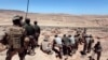 FILE - U.S. Marines monitor a multinational military training exercise in Quweira, 186 miles south of Amman, Jordan, June 18, 2013.