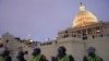 In this Jan. 6, 2021, photo, police form a line to guard the Capitol after violent rioters stormed the Capitol, in Washington.