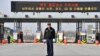  A South Korean security guard stands on the road leading to North Korea's Kaesong joint industrial complex, in front of the closed gate of the inter-Korean transit office in the border city of Paju on April 8, 2013. 