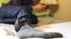 Jose, who did not want to use his real name, is an asylum seeker from Honduras. He wears a GPS monitor on his right leg, which he must charge for two hours every day.