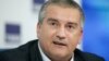 FILE - Crimean leader Sergei Aksyonov has caused a stir by traveling with Russian President Vladimir Putin to a summit in India.