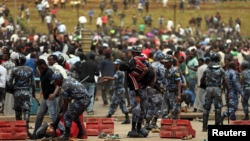 Federal Police assists protestors injured following the burial ceremony of Simegnew Bekele, 