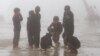 FILE - Children play during a class break on a foggy day, located on the China border on Sept. 21, 2015. Parents grew anxious after nearly 500 students from a middle school developed illnesses that are possibly linked contaminated soil and underground water adjacent to three former pesticide plants.