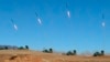 North Korea's artillery sub-units, whose mission is to strike Daeyeonpyeong island and Baengnyeong island of South Korea, conduct a live shell firing drill to examine war fighting capabilities in the western sector of the front line in this picture releas