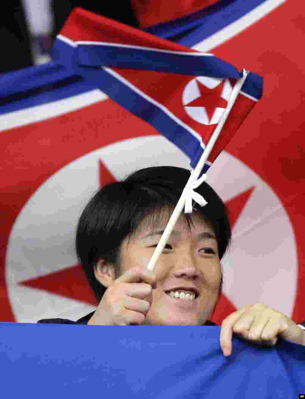 A North Korea supporter waves a flag before the team&#39;s group G women&#39;s soccer match against the United States at the London 2012 Summer Olympics, July 31, 2012 at Old Trafford Stadium in Manchester, England.